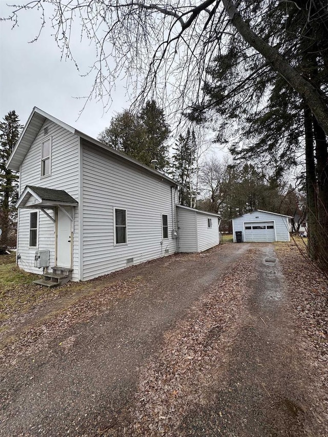 view of side of home with a garage and an outdoor structure