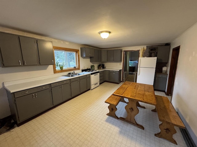 kitchen featuring gray cabinetry, white appliances, and sink