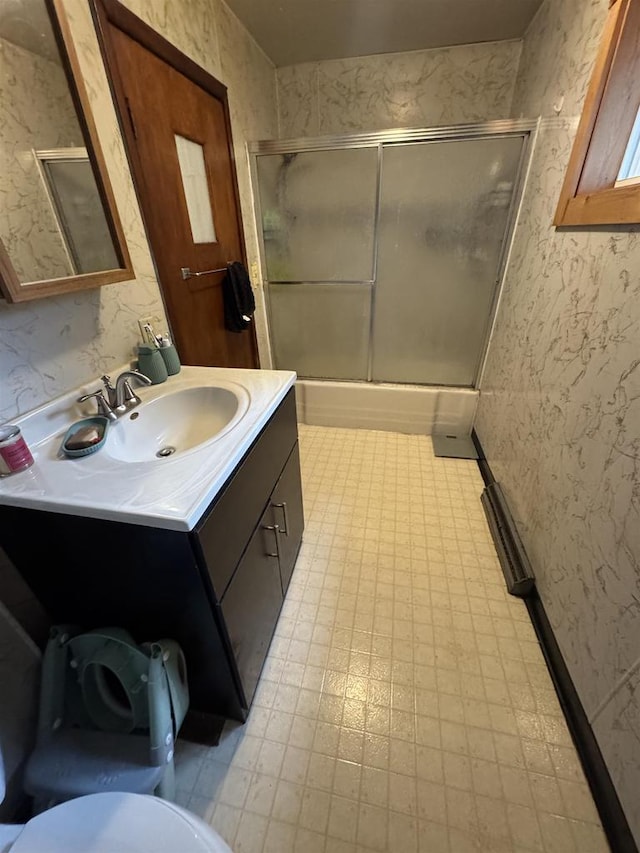 bathroom featuring vanity and enclosed tub / shower combo