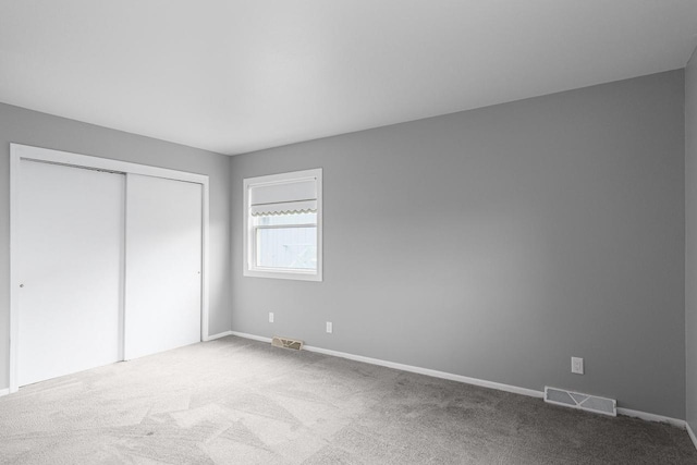 unfurnished bedroom with a closet and carpet