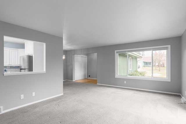 unfurnished living room with light carpet