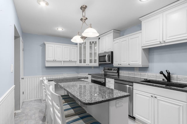 kitchen featuring white cabinets, stainless steel appliances, and sink