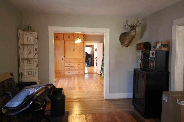 corridor with hardwood / wood-style floors