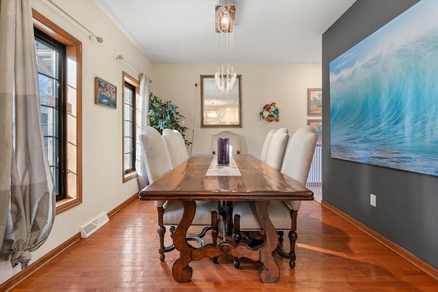 6461 Blue Heron Pointe Dr, Waterford, WI 53185 - dining area with wood-type flooring and an inviting chandelier