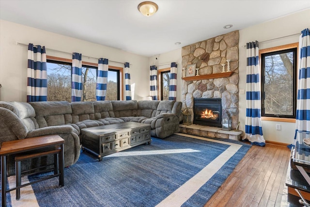 6461 Blue Heron Pointe Dr, Waterford, WI 53185 - living room featuring a stone fireplace and wood-type flooring