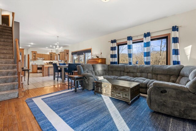 6461 Blue Heron Pointe Dr, Waterford, WI 53185 - living room featuring light hardwood / wood-style floors and a notable chandelier