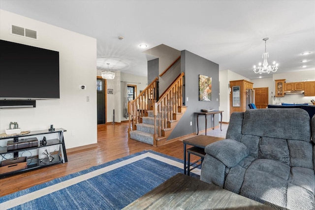 6461 Blue Heron Pointe Dr, Waterford, WI 53185 - living room with wood-type flooring and a notable chandelier