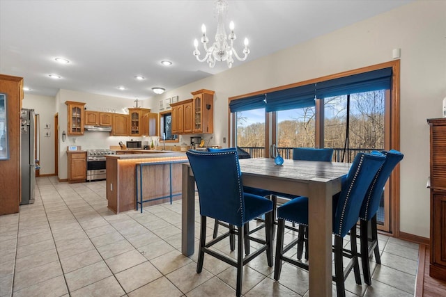 6461 Blue Heron Pointe Dr, Waterford, WI 53185 - dining room featuring light tile patterned floors, sink, and an inviting chandelier