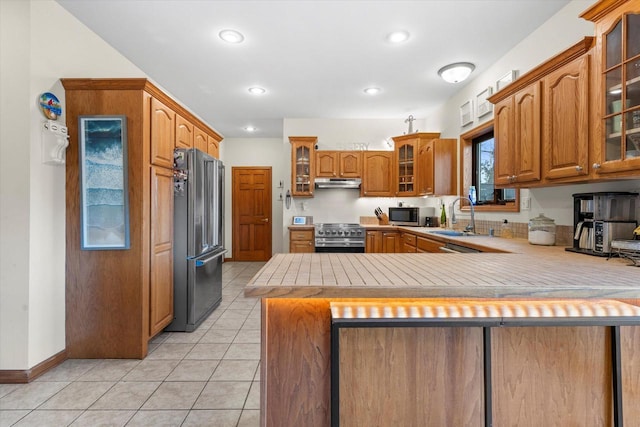 6461 Blue Heron Pointe Dr, Waterford, WI 53185 - kitchen with kitchen peninsula, appliances with stainless steel finishes, light tile patterned floors, and sink
