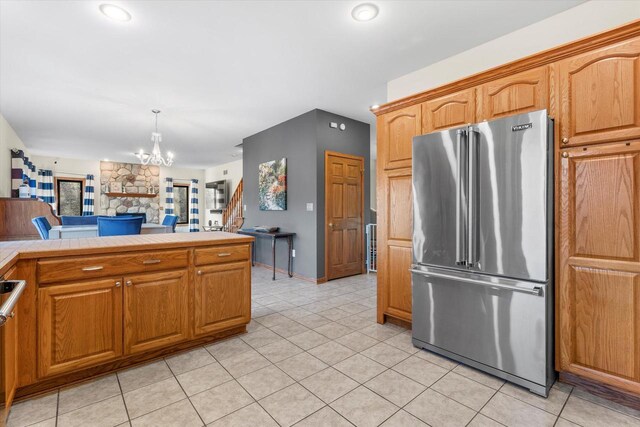 6461 Blue Heron Pointe Dr, Waterford, WI 53185 - kitchen featuring high quality fridge, light tile patterned flooring, decorative light fixtures, and a notable chandelier