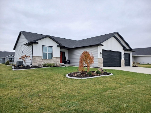 view of front of house with a front lawn, central AC unit, and a garage