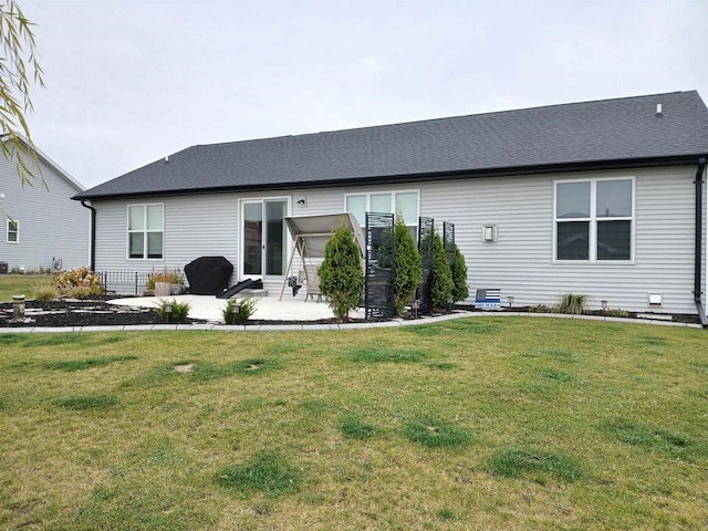 back of house featuring a patio area and a yard