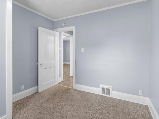 carpeted spare room featuring a textured ceiling