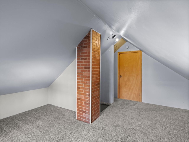 additional living space with carpet flooring and lofted ceiling