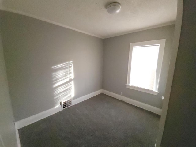 unfurnished room with dark carpet and crown molding