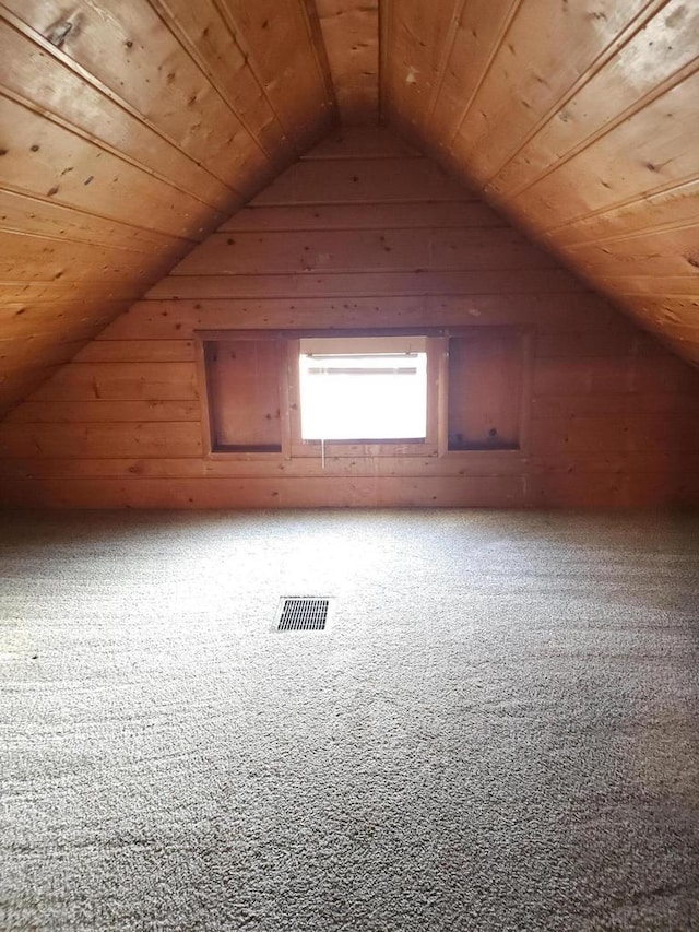 additional living space with wooden walls, carpet floors, wood ceiling, and lofted ceiling