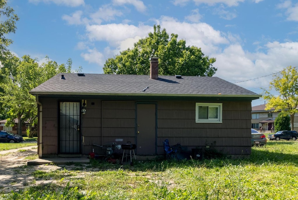 back of property featuring a yard