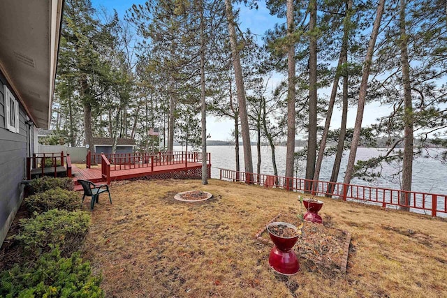 view of yard with a deck with water view