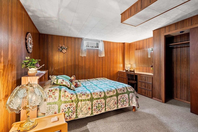 carpeted bedroom featuring wood walls and a closet