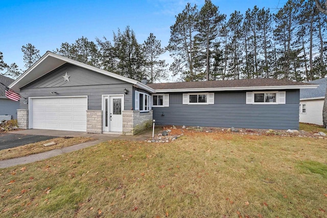 ranch-style home with a garage and a front lawn