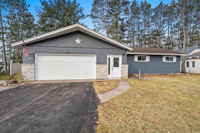 ranch-style home with a front yard and a garage