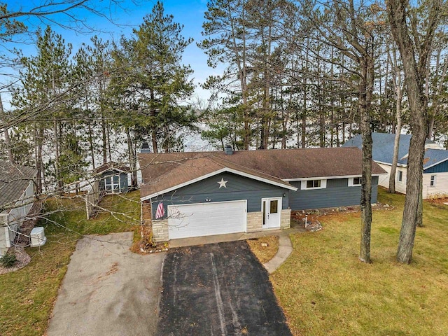 view of front facade with a garage and a front lawn