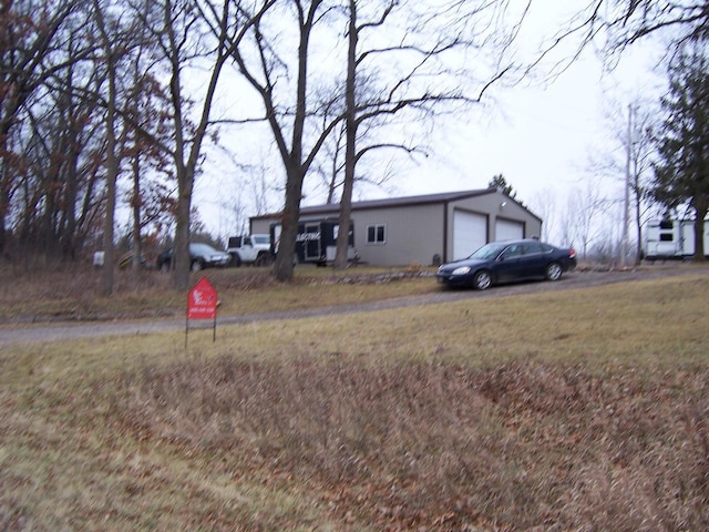 view of front facade with an outbuilding and a garage