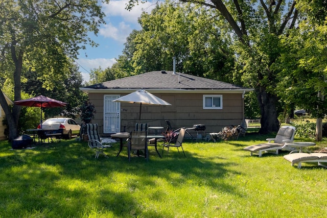 back of property with a lawn