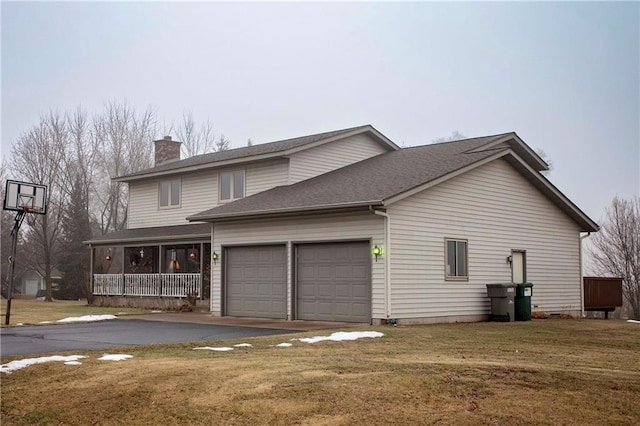 view of front of house with a front lawn, a porch, and a garage