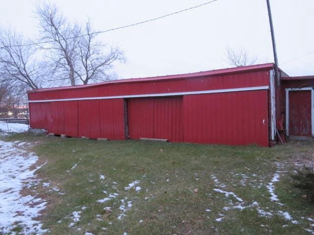 snow covered structure featuring a yard