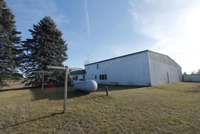 view of side of home with a yard