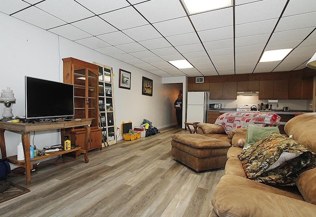 living room featuring a paneled ceiling and light hardwood / wood-style floors