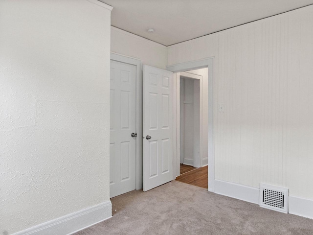 unfurnished room with light colored carpet