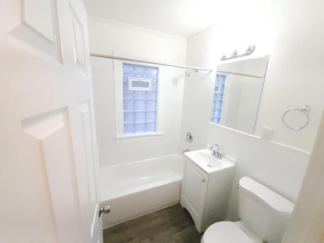 full bathroom featuring ornamental molding, vanity, shower / bathing tub combination, hardwood / wood-style floors, and toilet