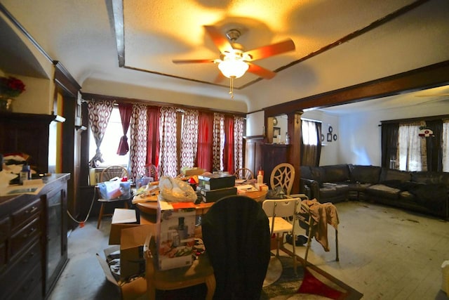 dining area with decorative columns and ceiling fan