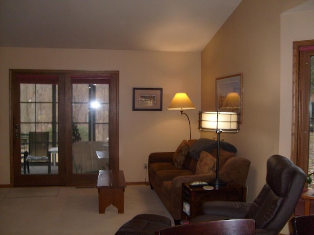 living room featuring carpet and vaulted ceiling