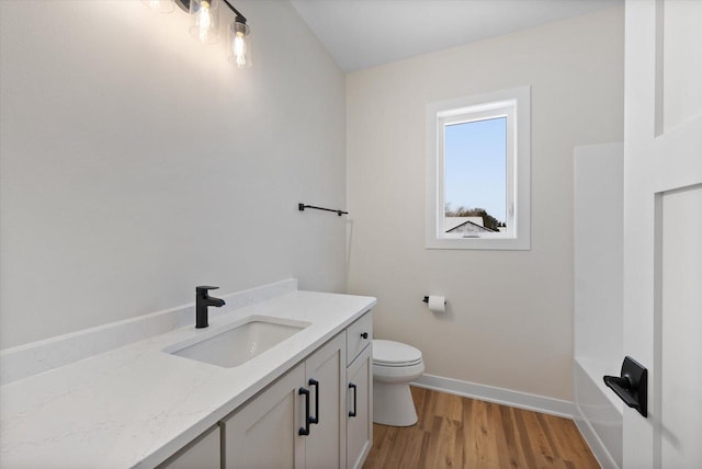 bathroom featuring hardwood / wood-style floors, vanity, and toilet