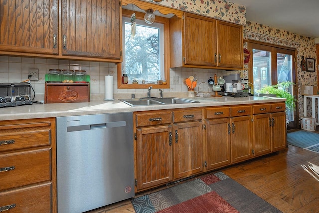 kitchen featuring stainless steel dishwasher, backsplash, dark hardwood / wood-style floors, and sink