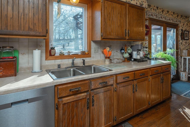 kitchen featuring dark hardwood / wood-style flooring, stainless steel dishwasher, plenty of natural light, and sink