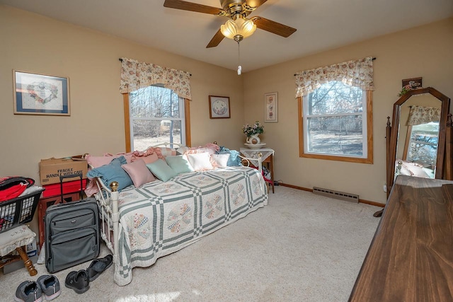 bedroom with ceiling fan, a baseboard radiator, multiple windows, and carpet flooring