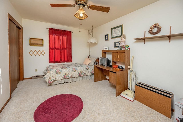 bedroom with a closet, carpet flooring, and a baseboard radiator