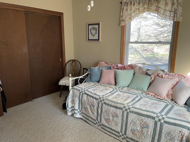 bedroom with light colored carpet and a closet