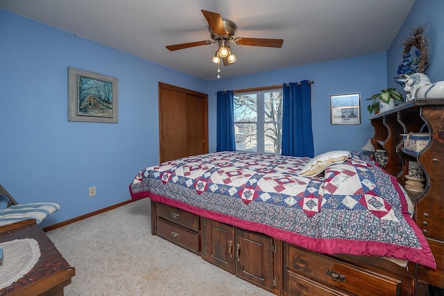 carpeted bedroom featuring ceiling fan and a closet