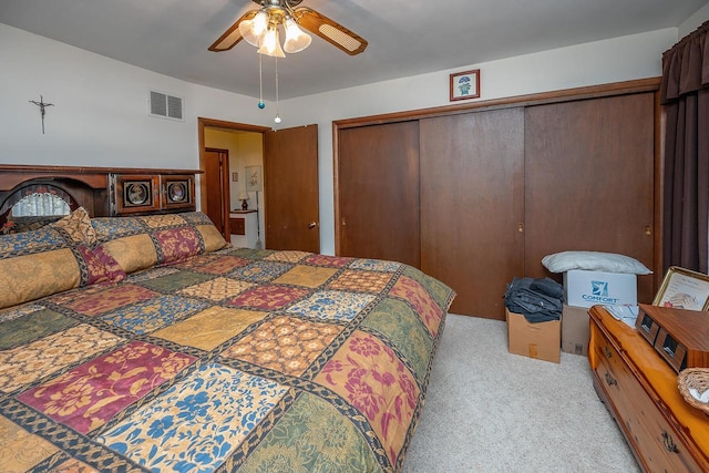 carpeted bedroom with ceiling fan and a closet