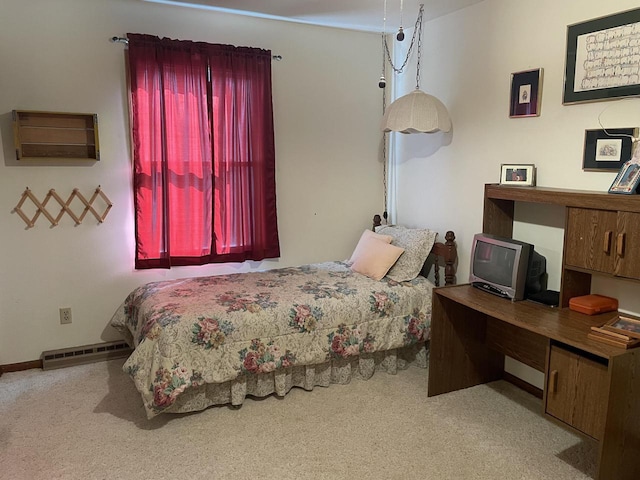 carpeted bedroom with a baseboard radiator