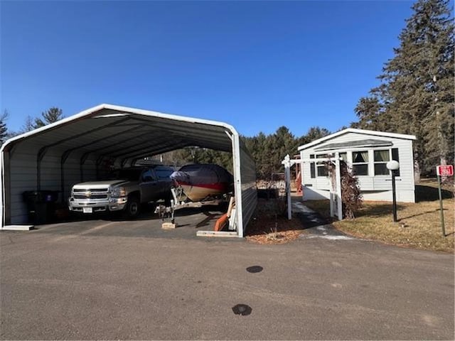 view of vehicle parking with a carport