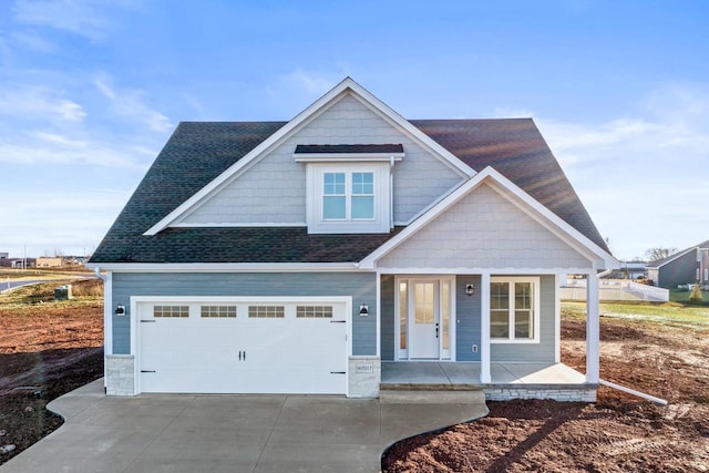 craftsman inspired home featuring a garage and covered porch