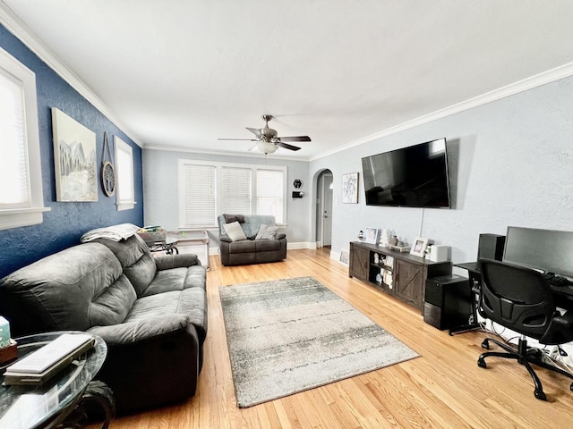 living room featuring ceiling fan, ornamental molding, and hardwood / wood-style flooring