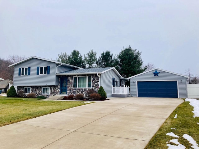 split level home with a garage, an outdoor structure, and a front lawn