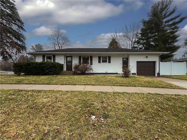 ranch-style home with a garage and a front lawn